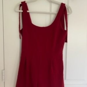 Red romper with tied shoulder straps